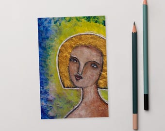May include: A painting of a woman with blonde hair and a light brown face. The background is a mix of blue, green, and yellow.