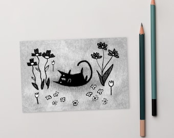 May include: A black and white illustration of a cat laying in a field of flowers. The cat is facing the left side of the image and has its tail curled around its body. The flowers are simple, stylized drawings of daisies and tulips.