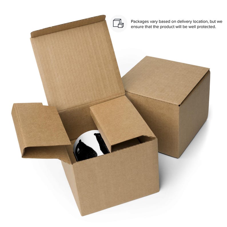 May include: A brown cardboard box with a smaller brown cardboard box inside. The smaller box is open and contains a white mug with a black and white design.