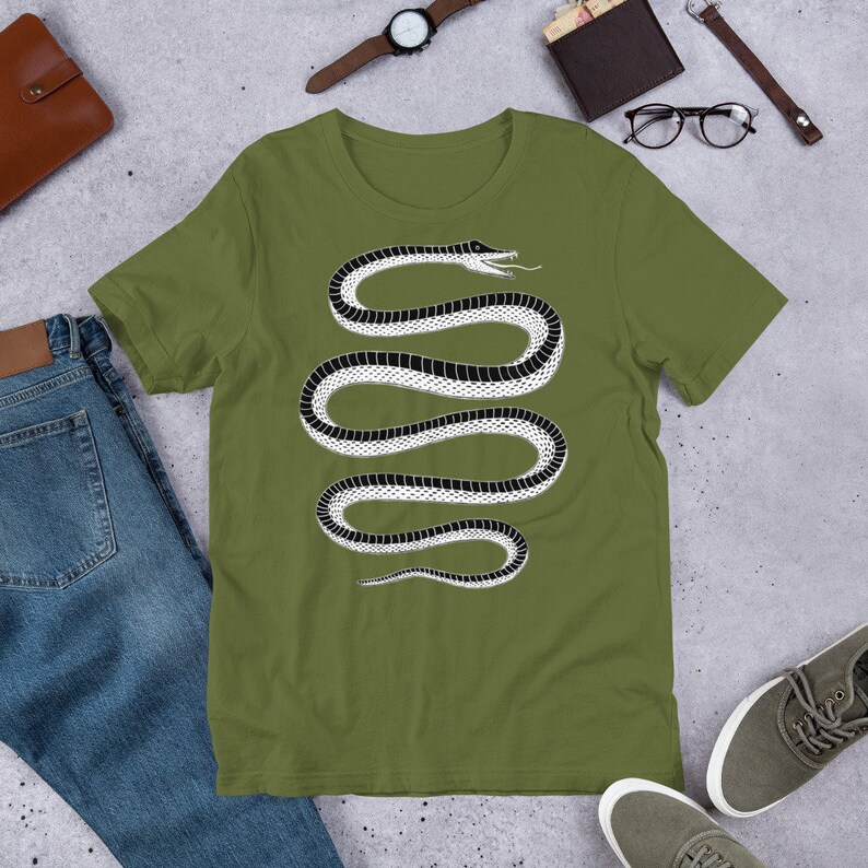 May include: A green t-shirt with a black and white snake graphic design. The snake is coiled and has a detailed pattern.