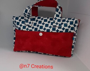 Blue and white skaï toiletry kit with a red pocket