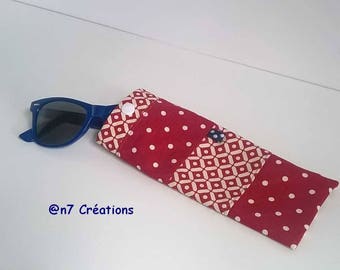 Red and ecru, glasses case with geometric patterns.