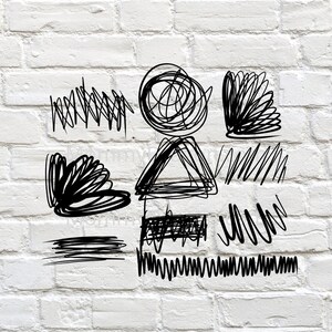 May include: A white brick wall with black ink drawings of various shapes and lines. The drawings include a circle, a triangle, a wavy line, and a series of squiggles.