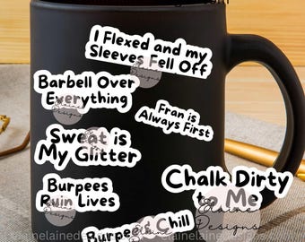 May include: A black coffee mug with several white stickers featuring fitness-related phrases like "Barbell Over Everything" and "Sweat is My Glitter." The mug has a handle and the text "LOVE MY STICKERS" at the top.