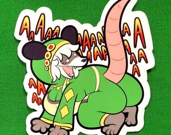 May include: A die-cut sticker featuring a cartoon opossum wearing a green hooded outfit with yellow diamond accents. The character has a long pink tail, white hair, and a wide-open mouth. The text "AAAA" is repeated in red and orange behind it.