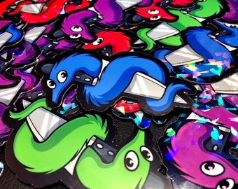 May include: A close-up of several colourful worm-shaped stickers with knives. The stickers are on a glittery background. The worms are green, blue, purple, and red.