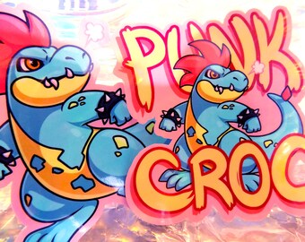 May include: A sticker featuring a cartoon crocodile with a red mohawk and the words "Punk Croc" in a stylised font.