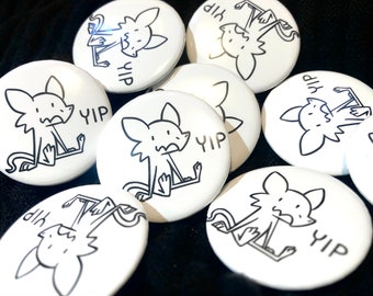 May include: A set of eight white round buttons with black line drawings of a cartoon animal with the word "yip" printed on each button.