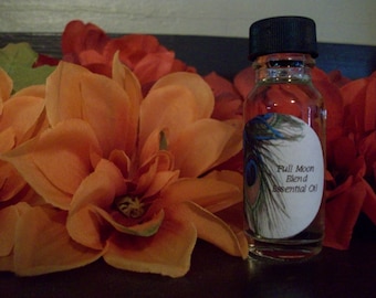 May include: A small clear glass bottle with a black cap and a white label that says "Full Moon Blend Essential Oil". The label has a peacock feather design.