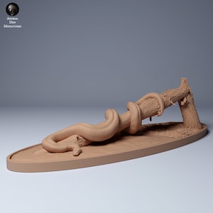 May include: A tan-colored miniature sculpture of a snake coiled around a tree branch. The snake is detailed with scales and curves, and the branch has textured bark. The sculpture is on an oval base. The text "ANIMAL DEN MINIATURES" is in the upper left corner.
