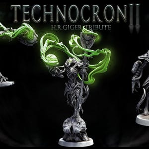May include: Three detailed, gray, sculpted figures with green glowing accents. The figures are standing on circular bases. The title "TECHNOCRONII H.R.GIGER TRIBUTE" is displayed above the figures.