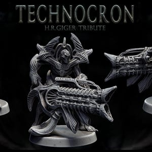 May include: Three gray, detailed, sci-fi figurines with intricate designs. The figures are holding weapons and are posed in a dynamic stance. The text "TECHNOCRON H.R.GIGER TRIBUTE" is displayed at the top of the image.