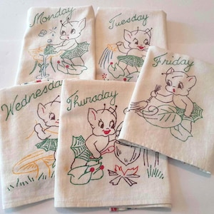 May include: Set of five vintage embroidered linen dish towels, each featuring a whimsical cartoon character and the days of the week: Monday, Tuesday, Wednesday, Thursday, and Friday. The towels have green and red accents.
