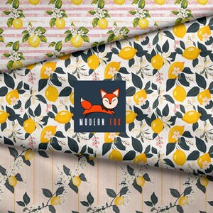 May include: A fabric pattern featuring yellow lemons, white blossoms, and dark green leaves on a white background, with a central square logo displaying a stylized orange fox and the text MODERN FOX, layered over striped sections.