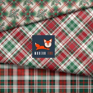 May include: Fabric featuring a red, green, and white plaid pattern with a top section displaying pine sprigs and red berries. A dark blue square logo in the center depicts an orange fox with the text MODERN FOX in white and orange.