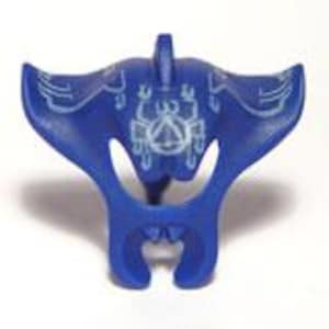 May include: A blue, stylized manta ray figurine with white etched details. The figurine has a wide, wing-like shape and a detailed underside. The design includes a central emblem and symmetrical patterns, suggesting a decorative or symbolic purpose.