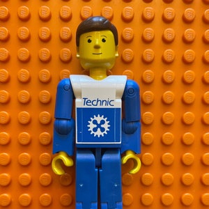 Vintage LEGO Technic Action Brown Hair Figure 3.5” Tall Minifigure Blue Legs, White Top with Blue Technic Logo, Blue Arms