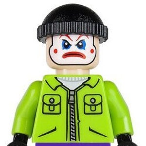 May include: A green and purple Lego minifigure of the Joker wearing a black beanie and a green jacket with a zipper. The Joker has a white face with a red smile and red circles around his eyes.