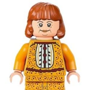 May include: A Lego minifigure with a light skin tone, wearing a yellow outfit with a brown and white pattern. The figure has short, reddish-brown hair and a smiling expression.