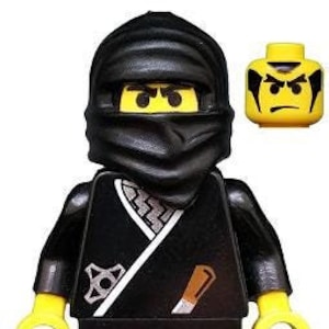 May include: A black Lego minifigure with a black ninja mask and a white sash. The minifigure has a yellow face with black eyes and a black mouth. The minifigure is holding a silver knife in its right hand.