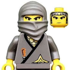 May include: A gray Lego minifigure with a gray ninja mask and a black belt. The minifigure has a yellow face with black eyes and a black mouth. The minifigure is holding a small, brown knife in its right hand.