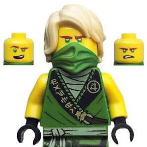 May include: A Lego Ninjago minifigure in a green and black outfit with a green mask. The figure has a yellow head with blonde hair and two additional yellow heads with different facial expressions.