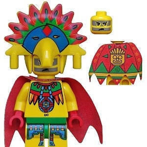 Könnte beinhalten: Eine gelbe Lego-Minifigur, die einen roten Umhang und einen bunten Kopfschmuck mit einem vogelartigen Gesicht trägt. Die Minifigur hat ein gelbes Gesicht mit einem Stirnrunzeln und einem schwarzen Bart. Die Minifigur hält einen roten Umhang in der rechten Hand. Die Minifigur trägt ein grün-blau gemustertes Hemd und eine Hose. Die Minifigur trägt auch eine Halskette mit einem Kreuzanhänger. Die Minifigur steht auf einem weißen Hintergrund.
