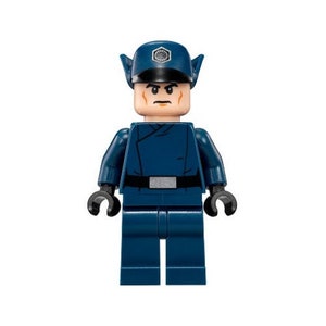 May include: A blue Lego minifigure of a Star Wars character wearing a dark blue uniform with a black belt and a dark blue hat with a silver emblem. The character has a light brown face with a dark brown mustache and eyebrows.