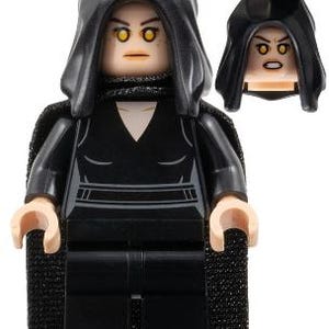 May include: A LEGO minifigure wearing a black hooded cape and a black outfit with a V-neckline. The figure has light skin, yellow eyes, and a neutral expression. An additional head piece with a black hood and an angry expression is shown separately.