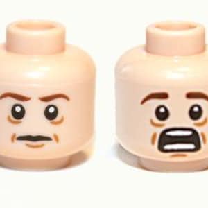 May include: Two Lego minifigure heads with different facial expressions. One head has a stern expression with a dark mustache and eyebrows. The other head has a surprised expression with an open mouth and raised eyebrows. Both heads are flesh-toned.