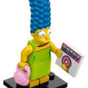 May include: A yellow LEGO minifigure of Marge Simpson from The Simpsons. She has blue hair, a green dress, and is holding a pink purse and a white sign that says "Donut Panic" with a pink donut graphic.