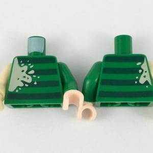 May include: Lego minifigure torso with green and white striped shirt and white splatter paint. The minifigure has light peach arms and light nougat hands.