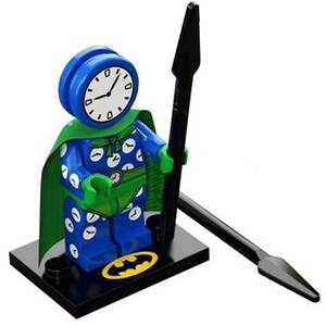 May include: A blue Lego minifigure with a clock face for a head, wearing a green cape and a blue and white polka dot suit. The minifigure is holding a black spear and standing on a black base with a yellow Batman logo.