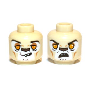 May include: Two tan plastic toy figure heads with printed feline facial features. The left head shows a smirk with visible teeth, while the right head displays an open-mouthed expression. Both feature orange eyes, dark brown markings, and white muzzles.