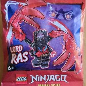 May include: A LEGO Ninjago Dragons Rising Lord Ras minifigure packet. The packet is red and yellow, with the LEGO logo and the Ninjago logo. The packet features a minifigure with red and black armor and the text "LORD RAS" and "6+".