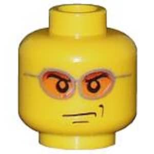 May include: A bright yellow plastic toy minifigure head featuring a printed design of orange-tinted oval sunglasses with thin grey frames. The face has a smirk with a raised eyebrow and a single curved line indicating a small smile on the right side.
