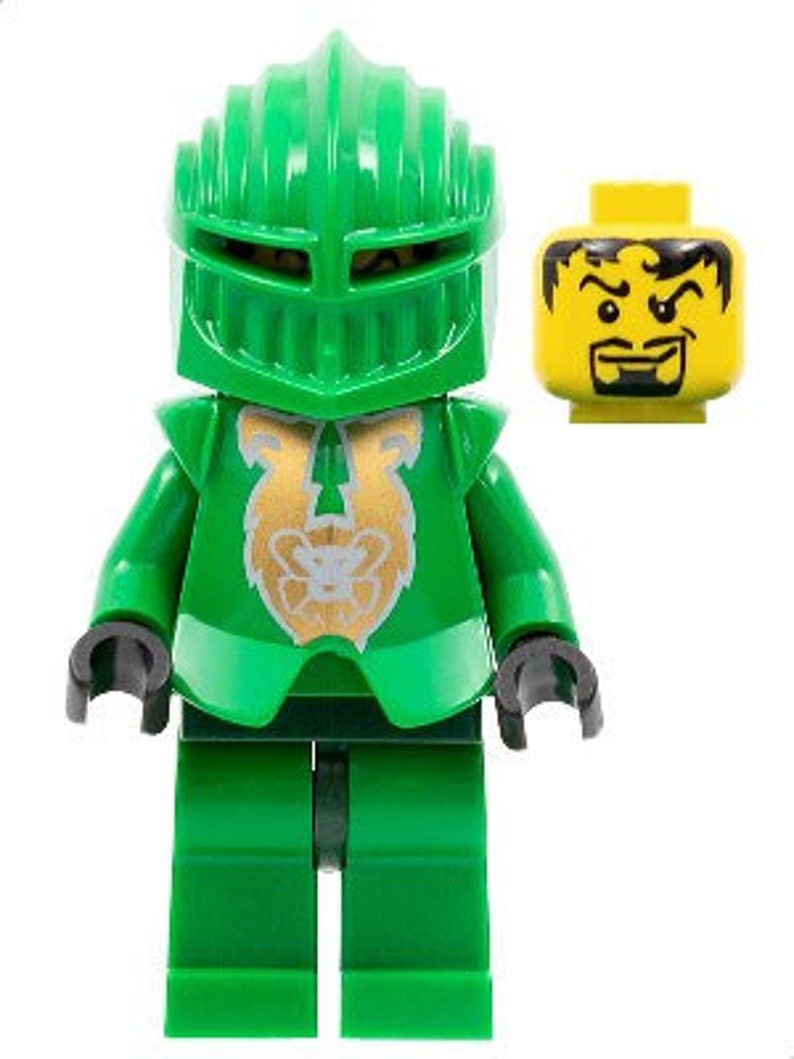 May include: A green Lego minifigure wearing a green helmet with a gold lion emblem on the chest. The minifigure has a black mouth and eyebrows. The minifigure is standing on a white background.