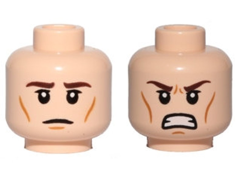 May include: Two Lego minifigure heads with different expressions. The head on the left has a neutral expression with furrowed brows and a slight frown. The head on the right has an angry expression with furrowed brows, a frown, and a gritted teeth expression.