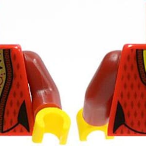 May include: A red plastic toy torso piece with yellow hands and arms. The front features a gold panel with a floral design and black trim. The back displays a red vest pattern with a gold neckline and a vertical row of buttons in black and gold.