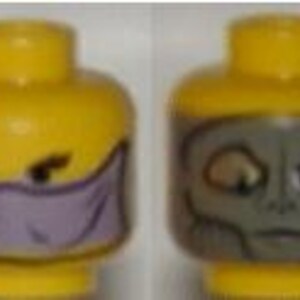 May include: Two yellow Lego minifigure heads. One head features a purple mask covering the lower face and angry eyes. The other head has a gray alien face with large eyes and a neutral expression.