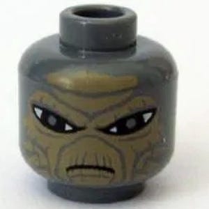 May include: A gray Lego minifigure head with a detailed, tan-colored face. The face has black eyes and a stern expression. The head is a standard Lego size and shape.