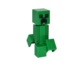 Könnte beinhalten: Eine grüne Minecraft Creeper Lego-Figur mit einem schwarzen Gesicht.