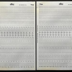 May include: Two sheets of white paper covered in small, black, stylized characters and symbols. The word "alfac" is printed at the top, along with the text "MAT-MODERNE 2.4 mm". The sheets are labeled "1108".