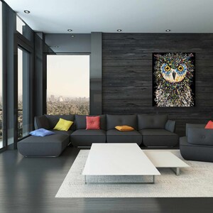May include: A modern living room with a sectional sofa, a coffee table, and a side table. The wall behind the sofa is covered in dark wood paneling and features a colorful abstract painting of an owl. The room has large windows with a view of a city skyline.