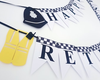 May include: A black and white banner with the words "Happy Retirement" in black letters. The banner is decorated with black and white checkered patterns. The banner is strung with black ribbon and includes a black police hat and a yellow safety vest.