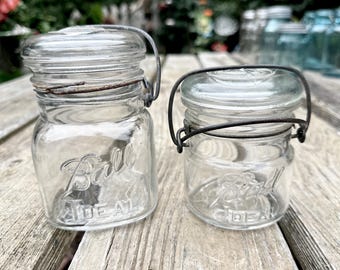 Set of 2 Ball Ideal 1920s-1930s clip wire bale glass top round and square pint and half pint jars  092659998