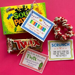 May include: A gift basket with a variety of treats, including a bag of Sour Patch Kids candy, a Twix chocolate bar, a scrunchie, and three inspirational cards with messages like "If you ever come across a Sour Patch in your life - turn to the Savior for help!" and "Don't let Satan play Twix on you. Always remember to make good choices!"