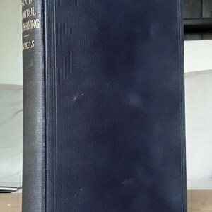 May include: A black hardcover book titled "Drainage and Flood Control Engineering" by H.N.C.  Tickels. The book is published by McGraw-Hill Book Company.