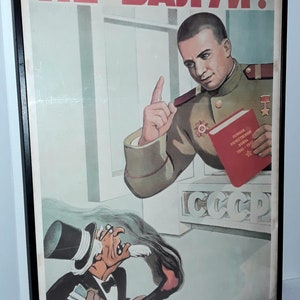 May include: A vintage Soviet propaganda poster with the text "Не балуй!" (Don't fool around!) in red letters. A man in a military uniform points his finger at a caricature of a man in a top hat and suit holding a burning torch. The poster also features the text "CCCP" (USSR) and a red book with the text "Великая Отечественная Война 1941-1945" (Great Patriotic War 1941-1945).