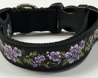 May include: Black dog collar with a purple floral pattern.